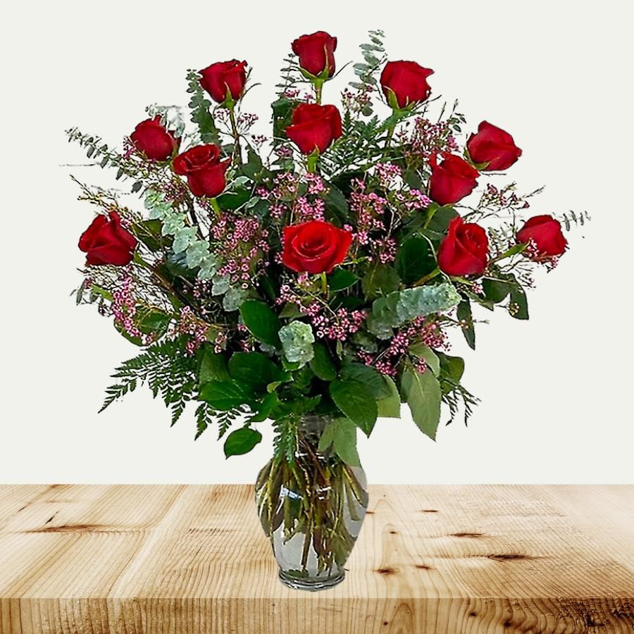 Dozen roses with waxflower
